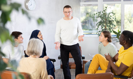 Male teacher lecturing with multinational students