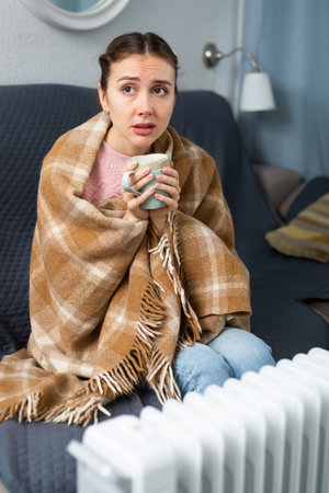 Woman feeling cold at home in winterの写真素材