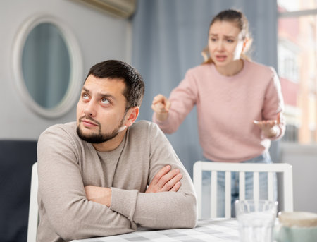 Young adult couple quarreling at homeの写真素材