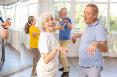 Couple of elderly man and woman dancing twist