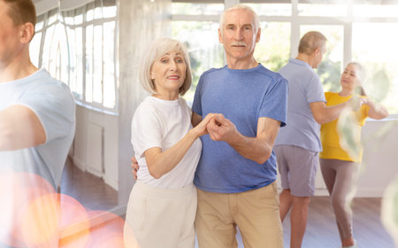 Couple of elderly man and woman dancing waltz