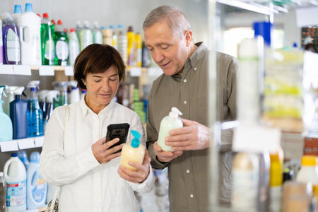 Husband and wife scanning the barcode of liquid soap packagingの写真素材