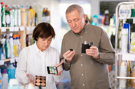 Couple man and woman choosing perfume and cosmeticsの写真素材