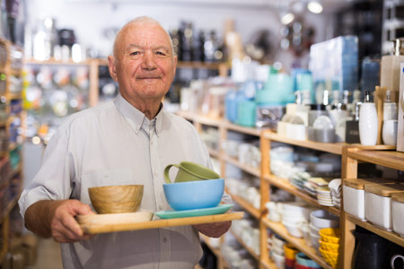 Senior man choosing variety goods for kitchenの写真素材