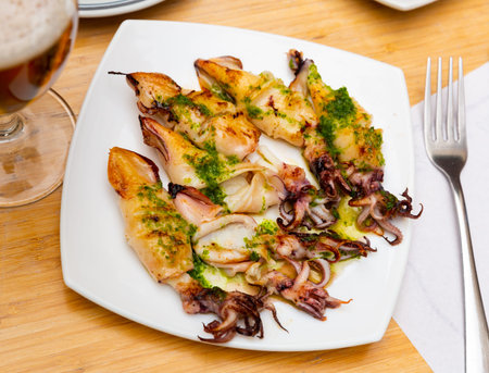 Traditional asian dish is barbecue squid,drizzled with spinach sauce.