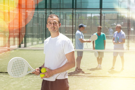 Young man posing on padel tennis courtの写真素材