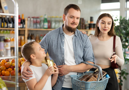 Man with wife and son shopping in grocery storeの写真素材
