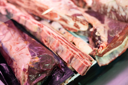 Pieces of raw beef lie in shop windowの写真素材