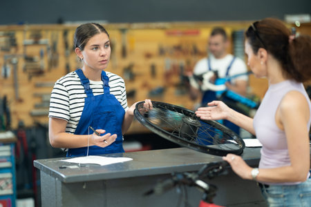 Female technician in bicycle workshop recording customer order detailsの写真素材