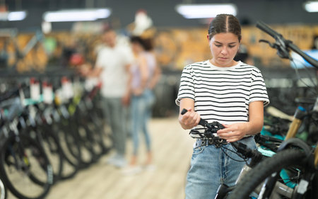 Young woman choosing bike in storeの写真素材