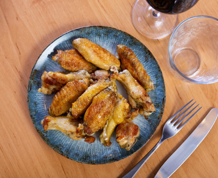 There is hearty snack on plate - large portion of chicken wingsの写真素材