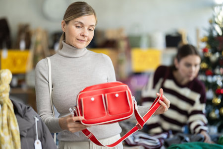 Adult woman choosing handbag in clothing storeの写真素材