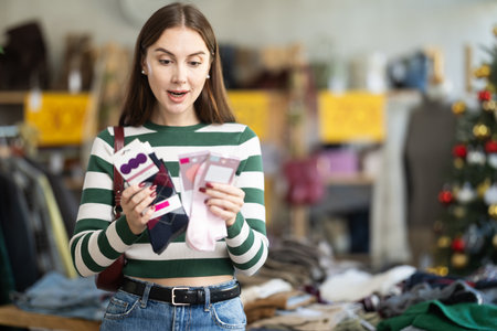 Young woman chooses socks in clothing storeの写真素材