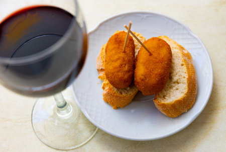 Fried croquettes served with bread on platterの写真素材