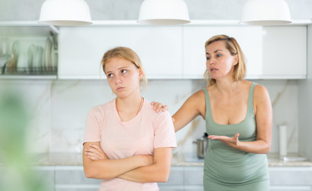 Upset teenage girl forced to listen to reprimands of disgruntled motherの写真素材