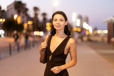 Young woman walking on promenade of Barcelonetaの写真素材