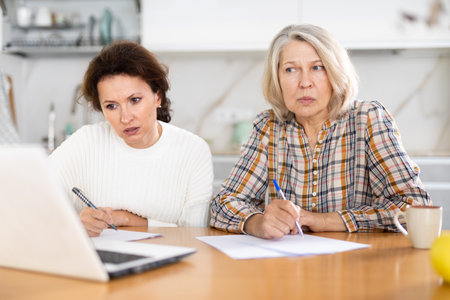 Old and middle-aged women joining distant education using laptopの写真素材