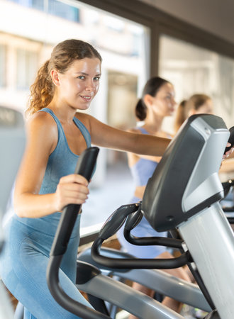 Woman training on elliptical machineの写真素材