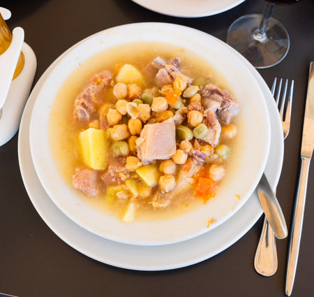 Popular dish of Spanish cuisine is Cocido de garbanzos, made from meat, vegetables and chickpeas, closeupの写真素材