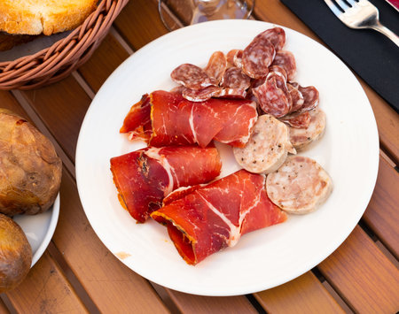 Slicing of smoked white sausages, ham and pieces