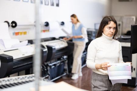 Printing office manager looking at display