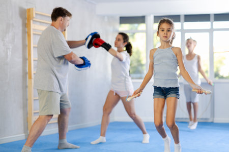 Little girl jumping rope in studioの写真素材