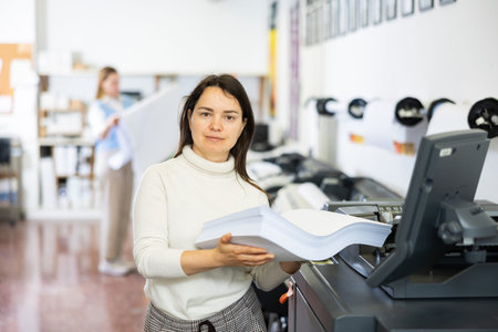 Portrait of positive woman printing office worker