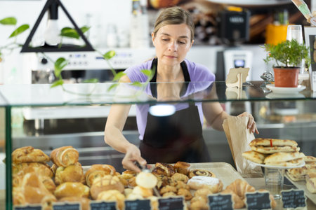 Female cafe employee offers to buy baked goods