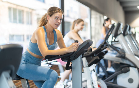 Woman exercising on an exercise bike in the gym
