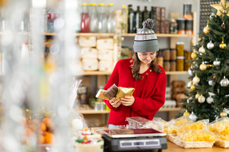 Adolescence girl customer choose consider desserts and sweet snacks.の写真素材
