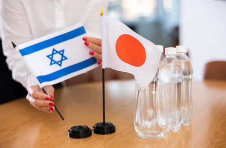 National flags of Japan and Israel on table in meeting roomの写真素材