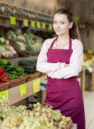 Female salesman standing in grocery storeの写真素材