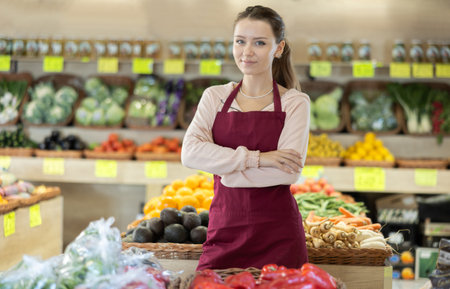 Female salesman standing in grocery storeの写真素材