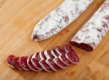 Slicing delicious Spanish smoked sausage fueteの写真素材