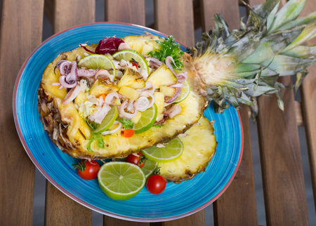 Stuffed pineapple with squid and lime.の写真素材
