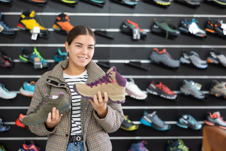 Girl examine compare item of winter comfortable tracking shoesの写真素材