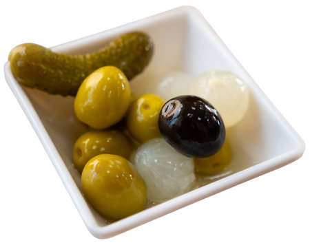 Bowl is filled with pickled vegetables - olives, small onions, gherkinsの写真素材