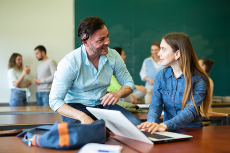 Woman and man chatting during recess in universityの写真素材