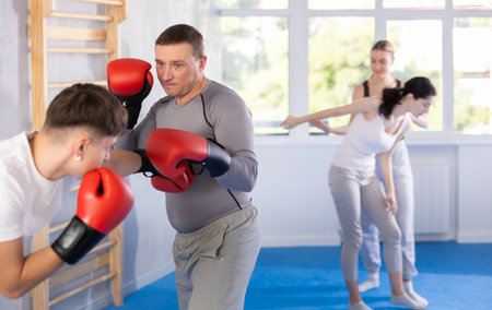 Two men training boxing fight in studioの写真素材