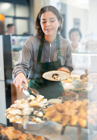 Woman folding fresh pastries