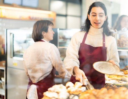Woman folding fresh pastries