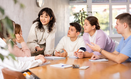 Female teacher working with teen students in classroom at schoolの写真素材