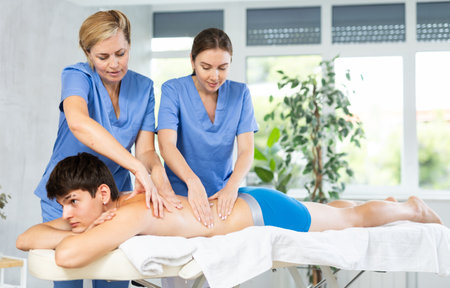 Professional masseuse teaching massage techniques to traineeの写真素材