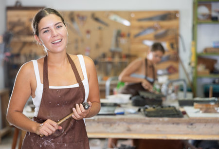 Young girl posing in workshopの写真素材