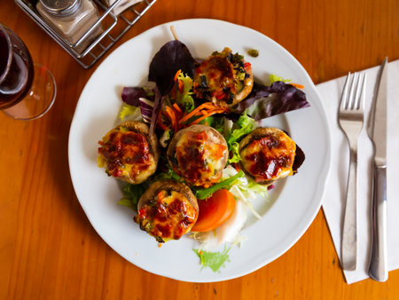 Baked mushrooms stuffed with vegetables, ham and mozzarellaの写真素材