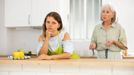Offended woman quarreling with her old mother at homeの写真素材