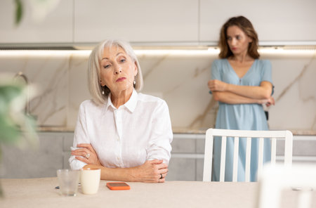 Adult woman quarreling with elderly woman in kitchenの写真素材