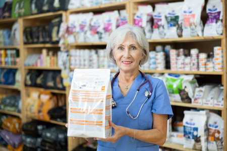 Smiling female veterinarian holding bag with healthy dry pet foodの写真素材