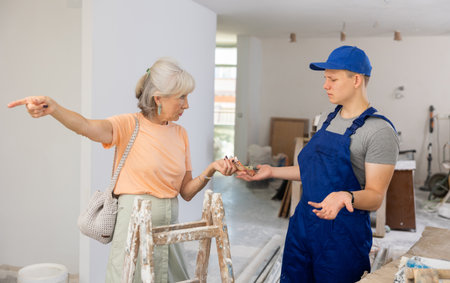 Guy is dissatisfied with the money received from an elderly woman for apartment renovationの写真素材