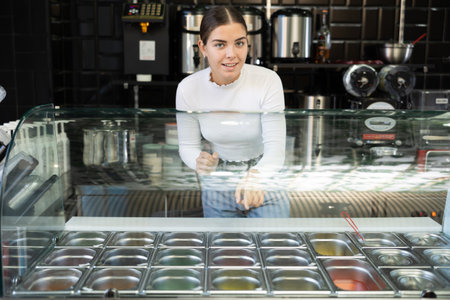 Young woman works as bartender and sells bubble teaの写真素材